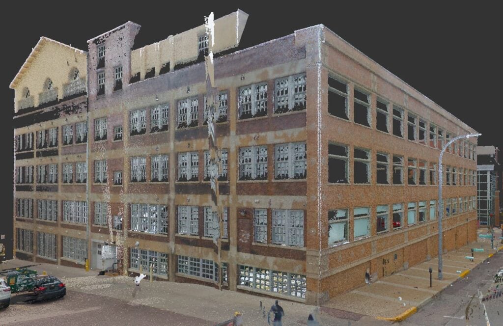 3D laser scan of a brick building showcasing detailed exterior features, windows, and surrounding environment, illustrating KC Engineering's expertise in 3D Scan to BIM services for construction and renovation projects.