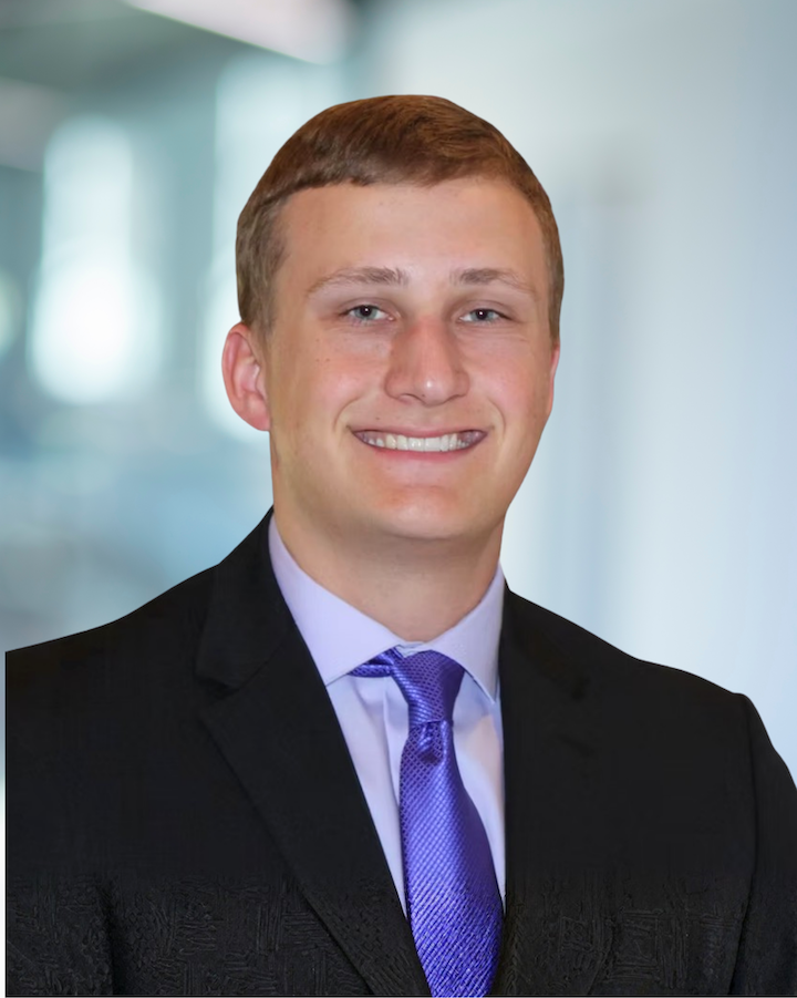 Cody Christensen, Engineer Intern at KC Engineering, smiling in professional attire with a purple tie, showcasing his role and background in civil engineering.