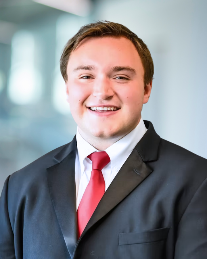 Ryan VanWyhe, Design Engineer at KC Engineering, smiling in professional attire with a red tie, showcasing his approachable demeanor and expertise.