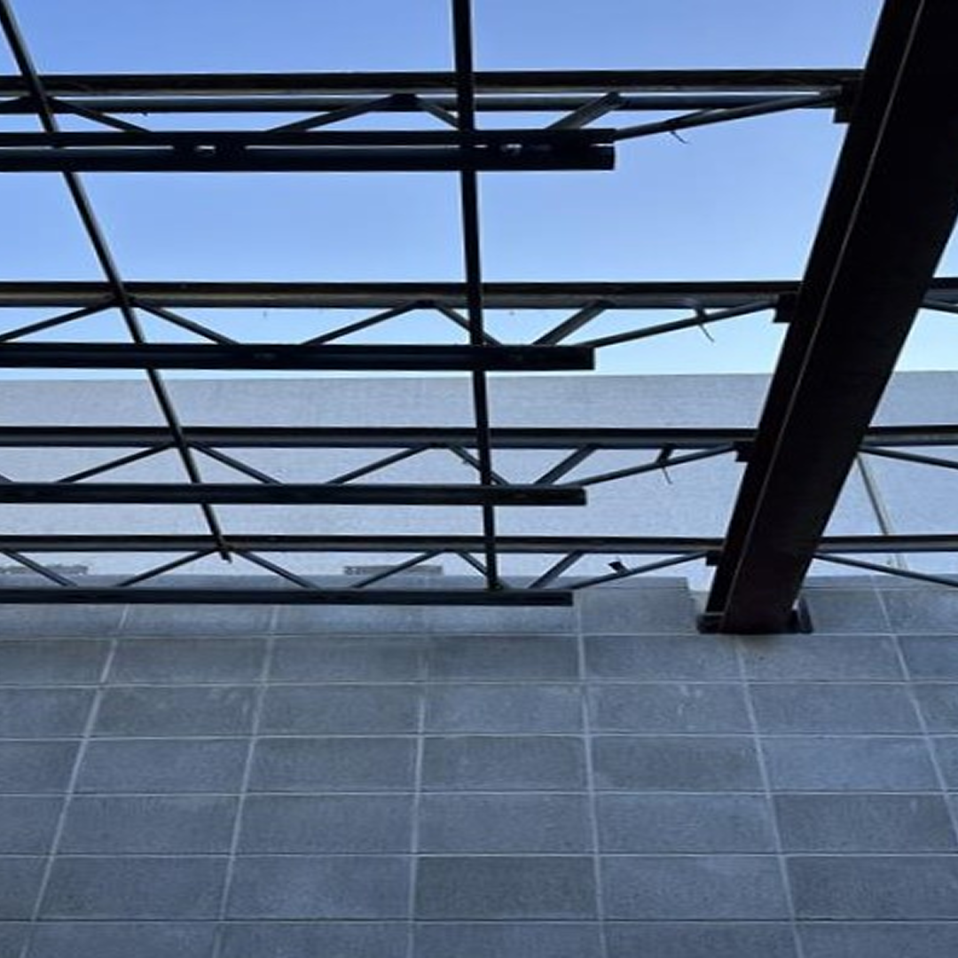 Structural framework and concrete wall under construction, showcasing architectural design and engineering collaboration.