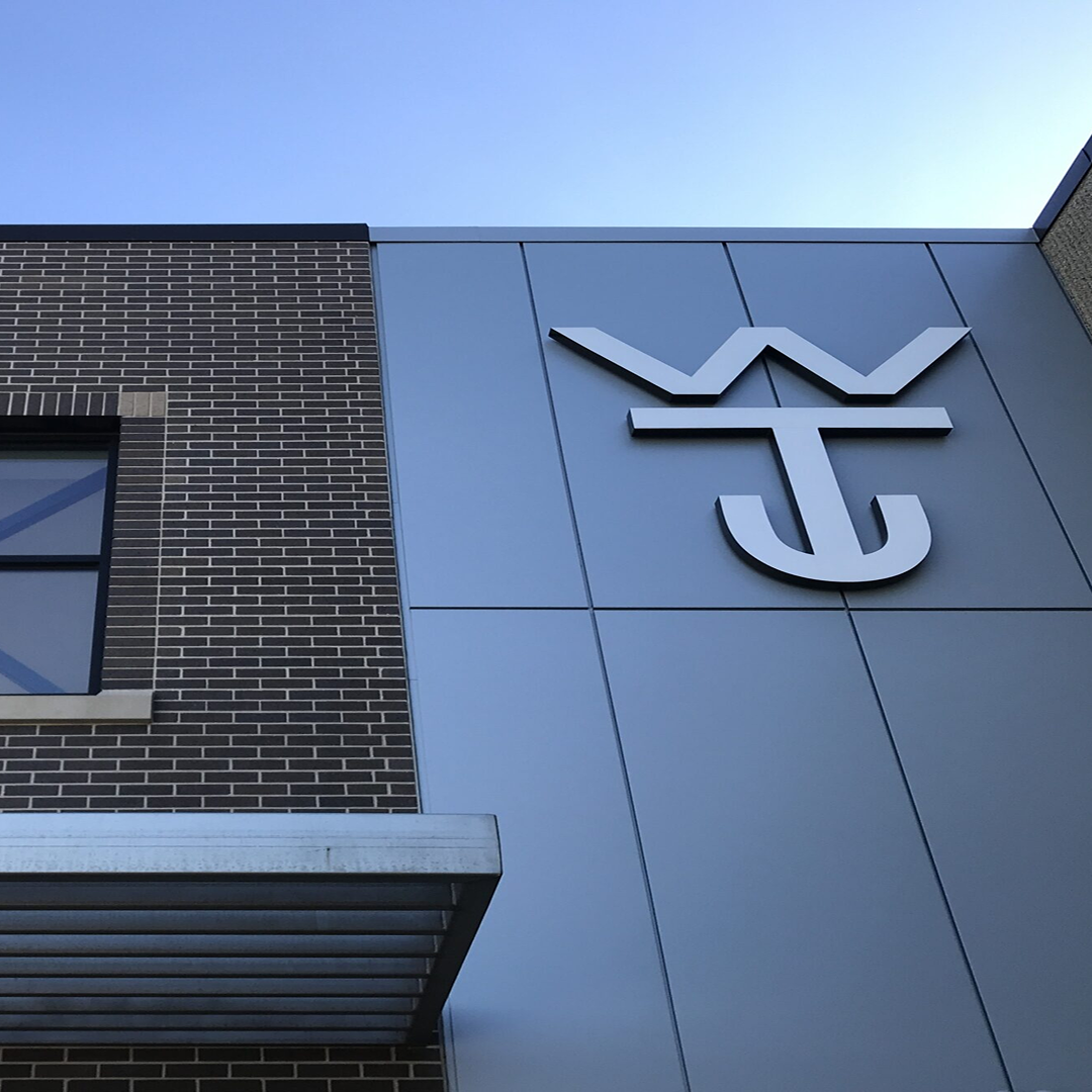 Wilson Trailer Company logo on a modern building facade, showcasing architectural design and structural elements relevant to KC Engineering's focus on practical and code-compliant solutions.